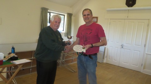 Chris presents the skittles winner trophy to Paul 
